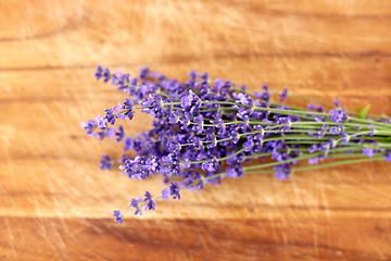 Image showing bunch of lavender flowers on wooden board