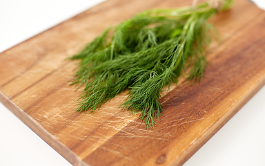 Image showing bunch of dill on wooden cutting board