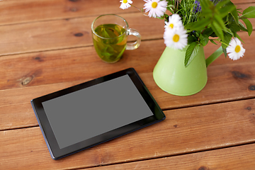 Image showing tablet computer, herbal tea and flowers in jug