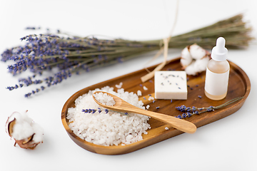 Image showing sea salt, lavender soap and serum on wooden tray