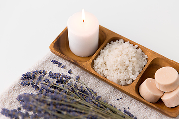 Image showing sea salt, soap, candle and lavender on bath towel