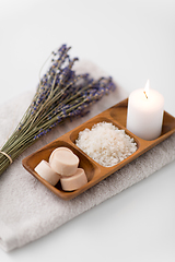 Image showing sea salt, soap, candle and lavender on bath towel