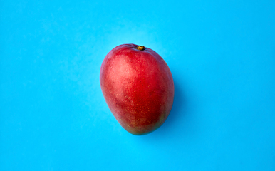 Image showing close up of ripe mango on blue background