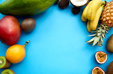 Image showing different exotic fruits on blue background