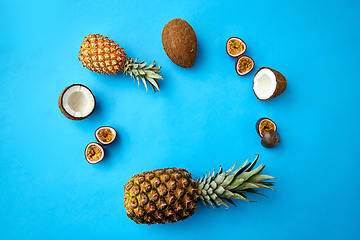 Image showing pineapple, passion fruit and coconut on blue