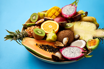 Image showing plate of exotic fruits on blue background