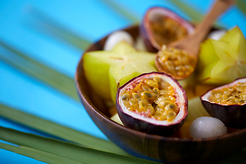 Image showing close up of of exotic fruits mix with wooden spoon