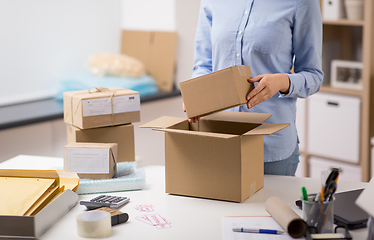 Image showing woman packing parcel box at post office