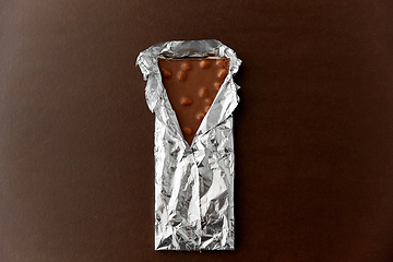 Image showing milk chocolate bar with nuts in foil wrapper