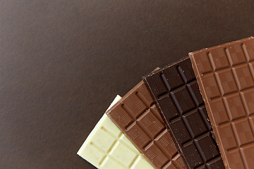 Image showing different kinds of chocolate on brown background