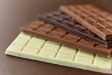 Image showing different kinds of chocolate on brown background