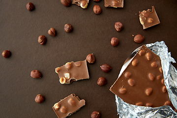 Image showing milk chocolate bar with hazelnuts in foil wrapper