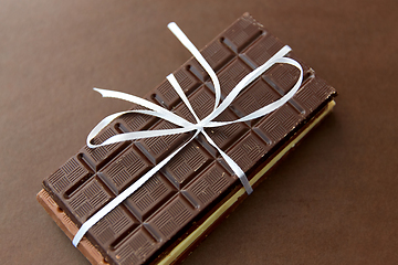 Image showing different kinds of chocolate on brown background