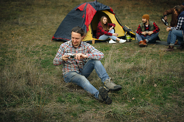 Image showing Group of friends on a camping or hiking trip in autumn day