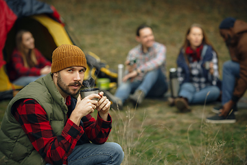 Image showing Group of friends on a camping or hiking trip in autumn day