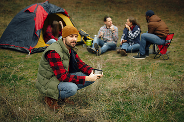 Image showing Group of friends on a camping or hiking trip in autumn day