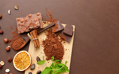 Image showing chocolate with hazelnuts, cocoa beans and powder