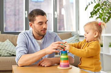 Image showing father playing with little baby daughter at home