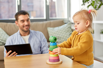 Image showing father with tablet pc and baby daughter at home