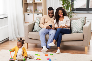 Image showing african baby girl playing with toy blocks at home