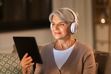 Image showing senior woman in headphones listening to music