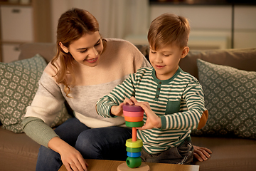 Image showing mother and son playing with toy pyramid at home