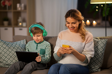 Image showing mother and son using gadgets at home