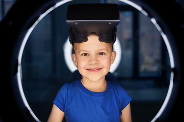 Image showing boy in vr glasses over illumination in dark room