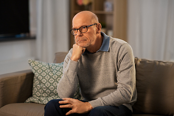 Image showing sad senior man in glasses thinking at home