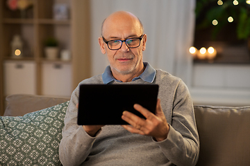 Image showing happy senior man with tablet computer at home