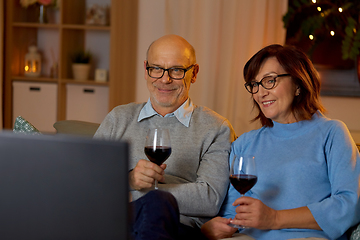 Image showing happy senior couple drink red wine and watch tv