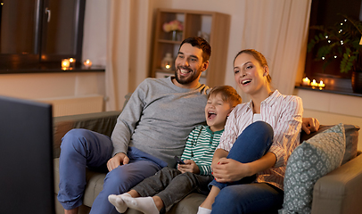 Image showing happy family watching tv at home at night