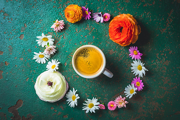 Image showing Cup of coffee with variation of flowers on green background