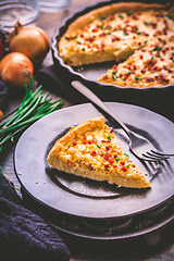 Image showing Piece of homemade onion tart or pie with bacon and chives