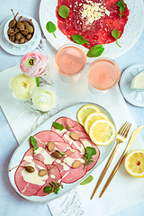 Image showing Appetizers - Vitello tonnato and beef Carpaccio with two glasses of rose wine