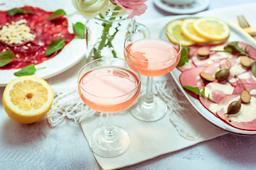 Image showing Appetizers - Vitello tonnato and beef Carpaccio with two glasses of rose wine