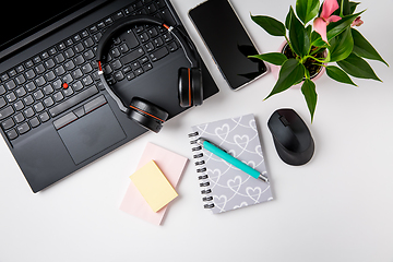 Image showing Workplace and office desk with laptop, headset and smarthpone