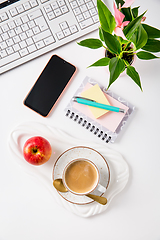 Image showing Workplace and office desk with coffee, apple, laptop, headset and smarthpone