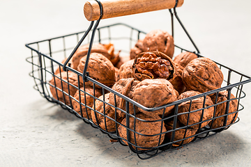 Image showing Organic walnuts in basket on kitchen table