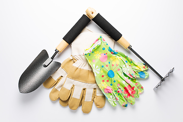 Image showing Garden tools with garden gloves on white background