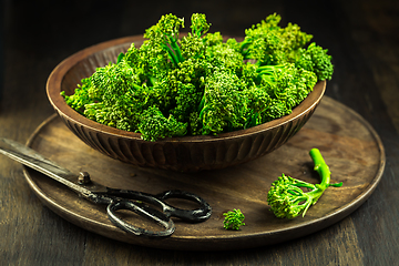 Image showing Organic Broccolini (bimi) in bowl on wooden background