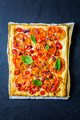 Image showing Vegetarian tomato tart or puffed pizza with herbs