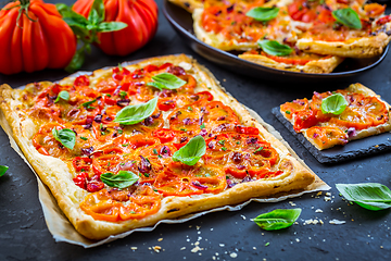 Image showing Vegetarian tomato tart or puffed pizza with herbs