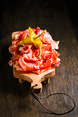 Image showing Prosciutto with grilled peppers -  Italian dry ham with grilled green peppers