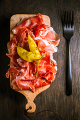 Image showing Prosciutto with grilled peppers -  Italian dry ham with grilled green peppers