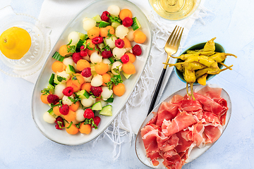 Image showing Cucumber and melon salad with raspberries and Prosciutto with grilled peppers 