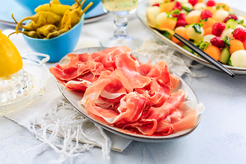 Image showing Cucumber and melon salad with raspberries and Prosciutto with grilled peppers 