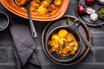 Image showing Goulash with potatoes and sauerkraut. Beef and vegetable stew in clay pot