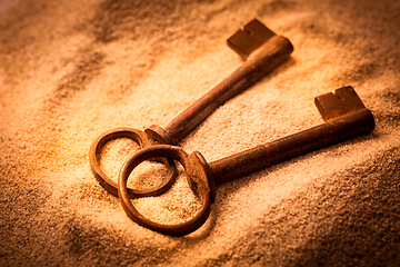 Image showing Two old rusty keys in sand