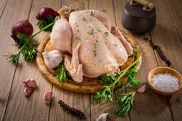 Image showing Raw chicken with onion, garlic and herbs with spices ready for cooking